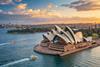 Sydney,Opera,House,At,Sunset,With,Boats,On,Sydney,Harbour
