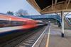 A high speed Network Rail train passing through the station