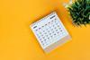 March,2024,Desk,Calendar,On,Yellow,Background.,Directly,Above.,Flat
