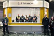 London Euston customer information hub with staff providing passenger support at station concourse