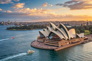 Sydney,Opera,House,At,Sunset,With,Boats,On,Sydney,Harbour