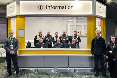 London Euston customer information hub with staff providing passenger support at station concourse