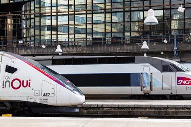 Two SNCF TGV inOui high-speed trains side by side at a station