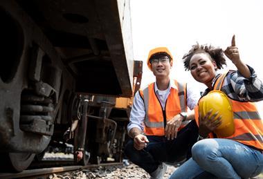 Diversity,Of,Engineers,Working,On,Railway,Train,Station,And,Holding