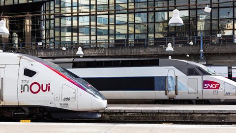 Two SNCF TGV inOui high-speed trains side by side at a station