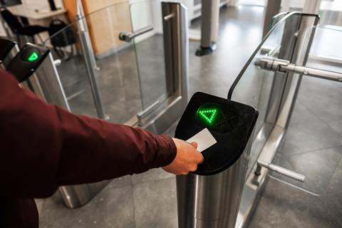 Close,Up,Of,Unrecognizable,Swiping,Card,Passing,Turnstile,To,Enter
