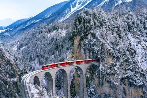 Aerial,View,Of,Train,Passing,Through,Famous,Mountain,In,Filisur,