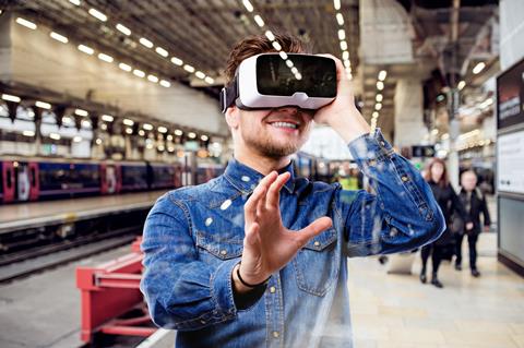 Man,Wearing,Virtual,Reality,Goggles,,Standing,At,Train,Station