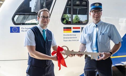 Pictured left is Arriva driver Björn Schoester handing over the train's ‘key’ to Belgian counterpart Gilles Dister (NMBS)_cropped